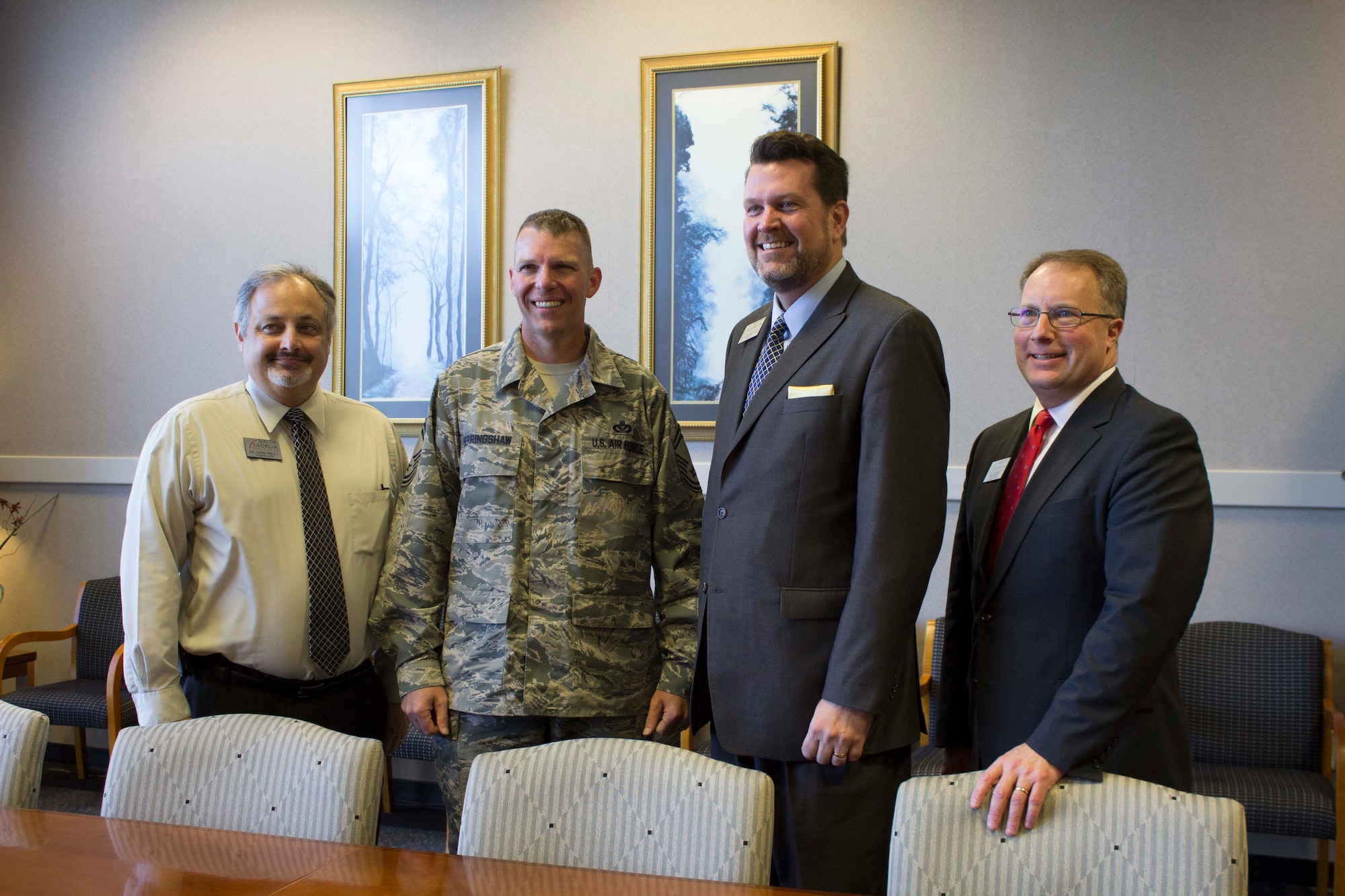 At center, Senior Master Sgt. Stewart Herringshaw pauses for a photo with South Georgia Technical College leaders during a collaboration of training efforts meeting at the college. The group discussed opportunities available to transitioning Airmen for a highly skilled workforce. (U.S. Air Force Photo/Susan Lawson)