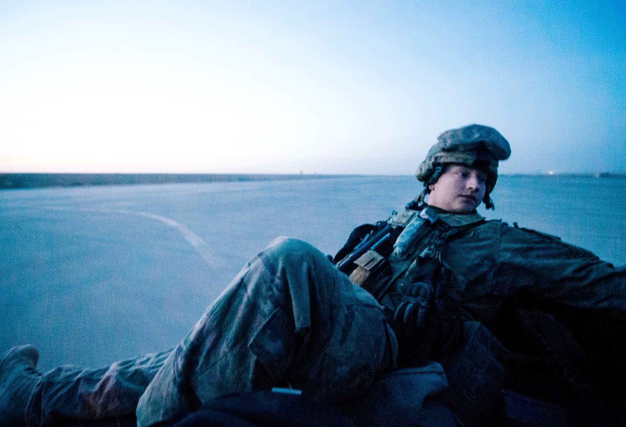Senior Airman Jacob Brooks, 821st Contingency Response Group aircraft maintainer, catches a ride in the back of a utility vehicle out to the airstrip at Qayyarah West Airfield, Iraq, in support of Combined Joint Task Force - Operation Inherent Resolve, Nov. 14, 2016. The airfield at Qayyarah West was recaptured from Da’esh by Iraqi forces in July 2016, and has been refurbished by Coalition engineers to allow the re-commencement of air operations. Qayyarah Airfield is now a vital logistical hub, opening an air corridor in support of the battle to liberate Mosul as well as operations throughout northern Iraq. (U.S. Air Force photo by Senior Airman Jordan Castelan)