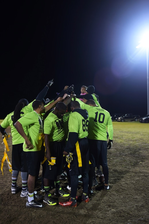 Team members from the Ryan Center celebrate after winning the Intramural Football Championship game at Joint Base Langley-Eustis, Va., Nov. 10, 2016. After the win and before they were awarded their trophy the team members all gathered together to congratulate each other. (U.S. Air Force photo by Senior Airman Kimberly Nagle)