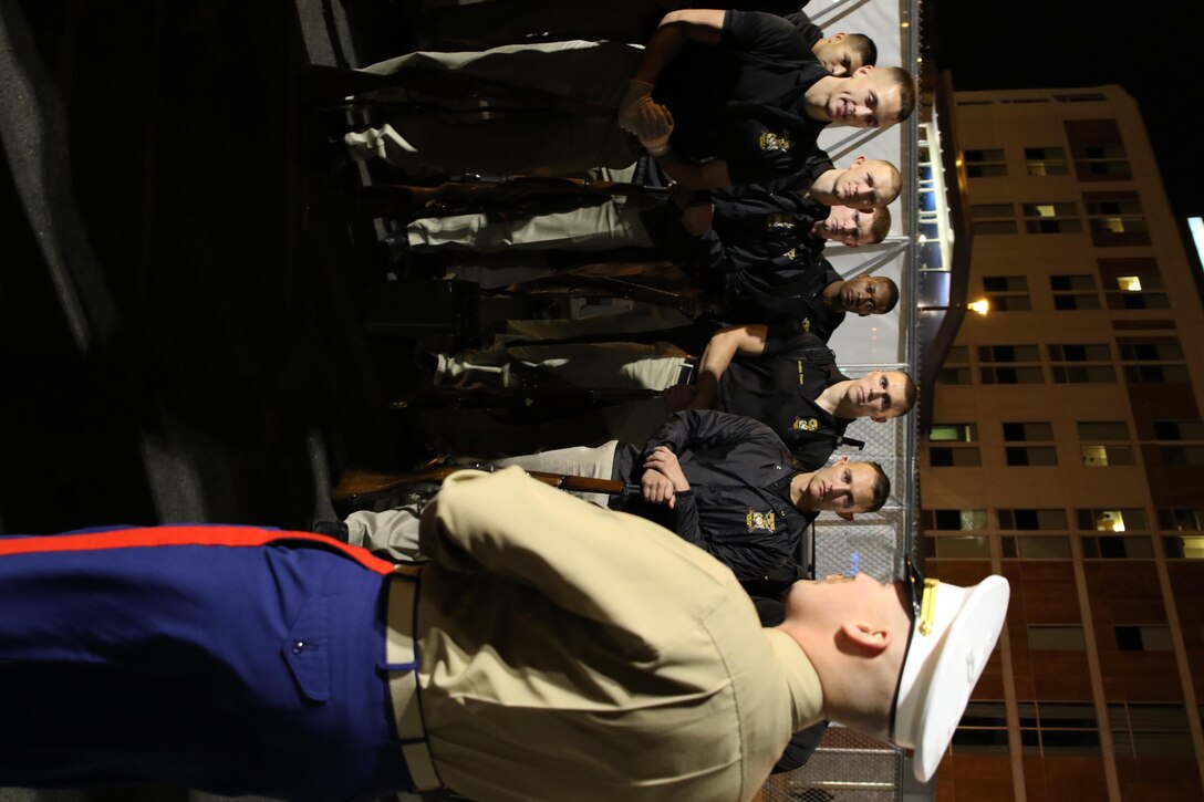 Capt. John Devroy, the executive officer of Recruiting Station Milwaukee, speaks with members of the Silent Drill Platoon prior to their performance at the Milwaukee Bucks game in downtown Milwaukee, Nov. 10, 2016. The platoon came to Milwaukee to demonstrate the precision and discipline that the Marine Corps is known across the world for having. This helps the efforts of the local recruiting station such as the one in Milwaukee, which is responsible for Marine Corps recruiting throughout Wisconsin. 