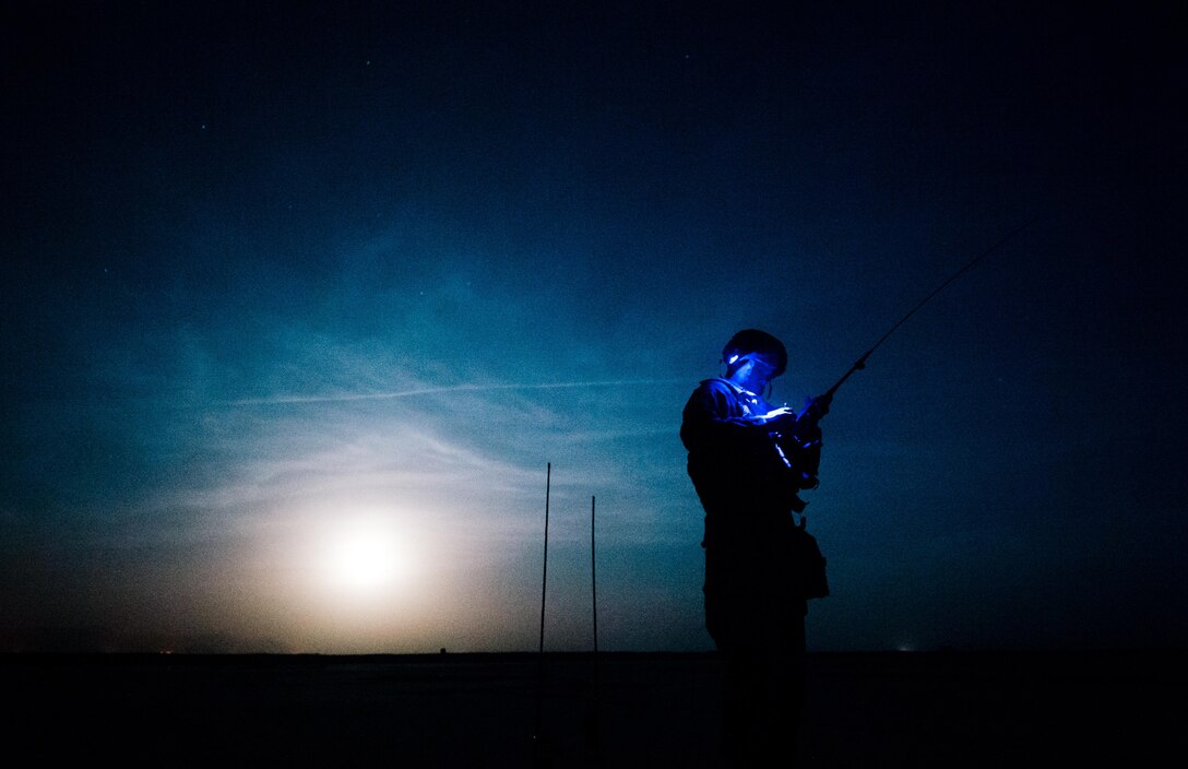 U.S. Air Force Master Sgt. Greylynn Carr, 821st Contingency Response Group air traffic controller, prepares for an arriving C-130 at Qayyarah West Airfield, Iraq, in support of Combined Joint Task Force - Operation Inherent Resolve, Nov. 14, 2016. The 821st CRG is highly-specialized in training and rapidly deploying personnel to quickly open airfields and establish, expand, sustain and coordinate air operations in austere, bare-base conditions. (U.S. Air Force photo by Senior Airman Jordan Castelan)