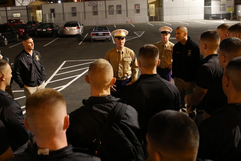 Capt. John Devroy, the executive officer of Recruiting Station Milwaukee, speaks with members of the Silent Drill Platoon prior to their performance at the Milwaukee Bucks game in downtown Milwaukee, Nov. 10, 2016. The platoon came to Milwaukee to demonstrate the precision and discipline that the Marine Corps is known across the world for having. This helps the efforts of the local recruiting station such as the one in Milwaukee, which is responsible for Marine Corps recruiting throughout Wisconsin.  