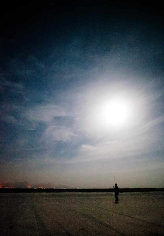 U.S. Air Force Staff Sgt. Steven Ramos, 821st Contingency Response Group airfield manager, prepares for an arriving C-130 at Qayyarah West Airfield, Iraq, in support of Combined Joint Task Force - Operation Inherent Resolve, Nov. 14, 2016. The airfield at Qayyarah West was recaptured from Da’esh by Iraqi forces in July 2016, and has been refurbished by Coalition engineers to allow the re-commencement of air operations. Qayyarah Airfield is now a vital logistical hub, opening an air corridor in support of the battle to liberate Mosul as well as operations throughout northern Iraq. (U.S. Air Force photo by Senior Airman Jordan Castelan)