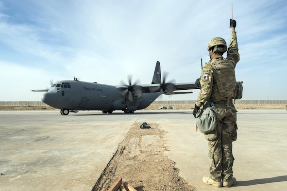Senior Airman Zevon Davis, 821st Contingency Response Group aircraft maintainer, marshals out an Iraqi C-130 Hercules at Qayyarah Airfield West, Iraq, Nov. 13, 2016. Senior Airman Zevon Davis, 821st Contingency Response Group aircraft maintainer, marshals out an Iraqi C-130 Hercules at Qayyarah Airfield West, Iraq, Nov. 13, 2016. The airfield at Qayyarah West was recaptured from Da’esh by Iraqi forces in July 2016, and has been refurbished by Coalition engineers to allow the re-commencement of air operations. Qayyarah Airfield is now a vital logistical hub, opening an air corridor in support of the battle to liberate Mosul as well as operations throughout northern Iraq. (U.S. Air Force photo by Staff Sgt. Charles Rivezzo)