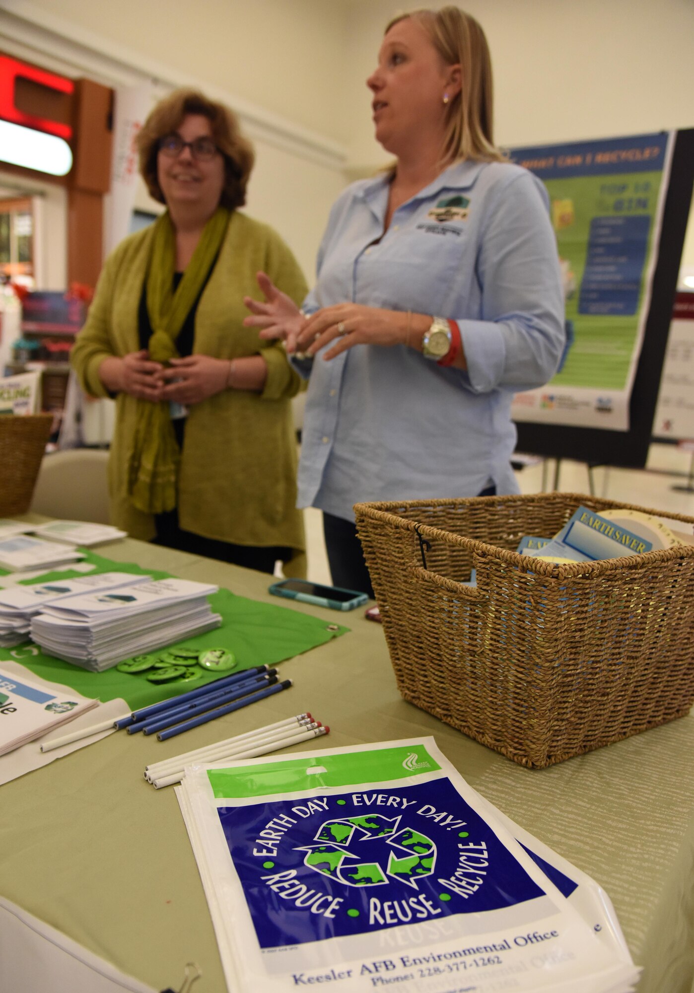 Susan Chamberlain, Base Operations Support community planner, and Kelly Griffin, Harrison County beautification director, provide educational recycling material to Keesler personnel at an American Recycling Day booth in The Exchange Nov. 15, 2016, on Keesler Air Force Base, Miss. Members of the base environmental office, recycling center and Harrison County Beautification Commission worked together to provide shoppers information about recycling. (U.S. Air Force photo by Kemberly Groue)