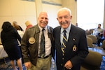 Retired U.S. Army Lt. Col. Alfred H.M. Shehab (right) stands with Mark Grapin, a contracting officer's representative in the Information Assurance Compliance Branch (Code 1043), after the Veterans Day observance ceremony on Nov. 9, 2016, at Naval Surface Warfare Center, Carderock Division in West Bethesda, Md. Shehab was the guest of honor at the ceremony and told the group about his time as a Cavalry officer during World War II, holding the line at the Battle of the Bulge in Monschau, Germany. Grapin, a chief warrant officer five in the Army Reserve, and Shehab shared stories about their time in the Cavalry. (U.S. Navy photo by Kelley Stirling/Released)