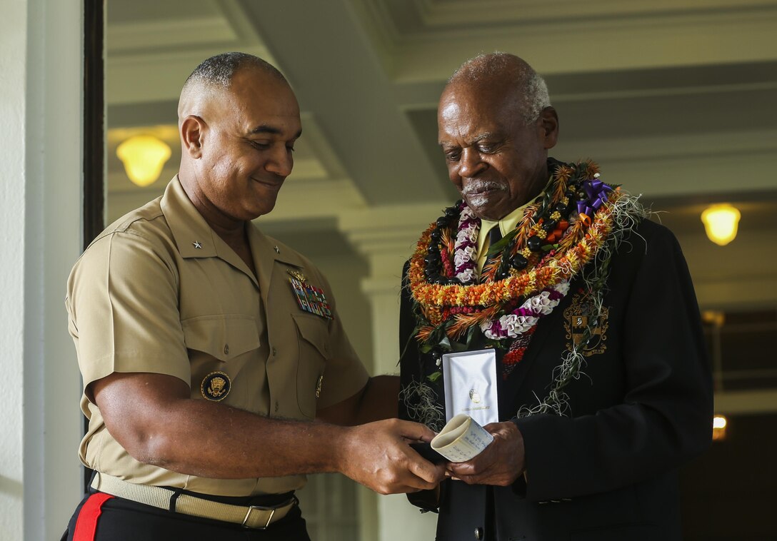 U.S. Marine Corps Brig. Gen. Brian W. Cavanaugh, deputy commander of U.S. Marine Corps Forces, Pacific, presents the Congressional Gold Medal to Dr. Ernest James Harris, Jr. in Honolulu Nov. 12, 2016. Harris was awarded his Congressional Gold Medal for his service as a Montford Point Marine. (U.S. Marine Corps photo by Cpl. Wesley Timm)
