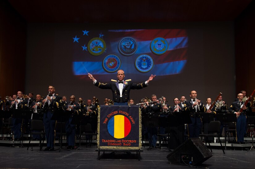 U.S. Army Maj. Randall Bartel, U.S. Army Training and Doctrine Command Band commander, conducts during the National Anthem at the Veterans Day Concert in Virginia Beach, Va., Nov. 11, 2016. The first anniversary of the end of World War I became known as Armistice Day on Nov. 11, 1919. In 1938, Armistice Day became a national holiday and later became Veterans Day in 1954. (U.S. Air Force 