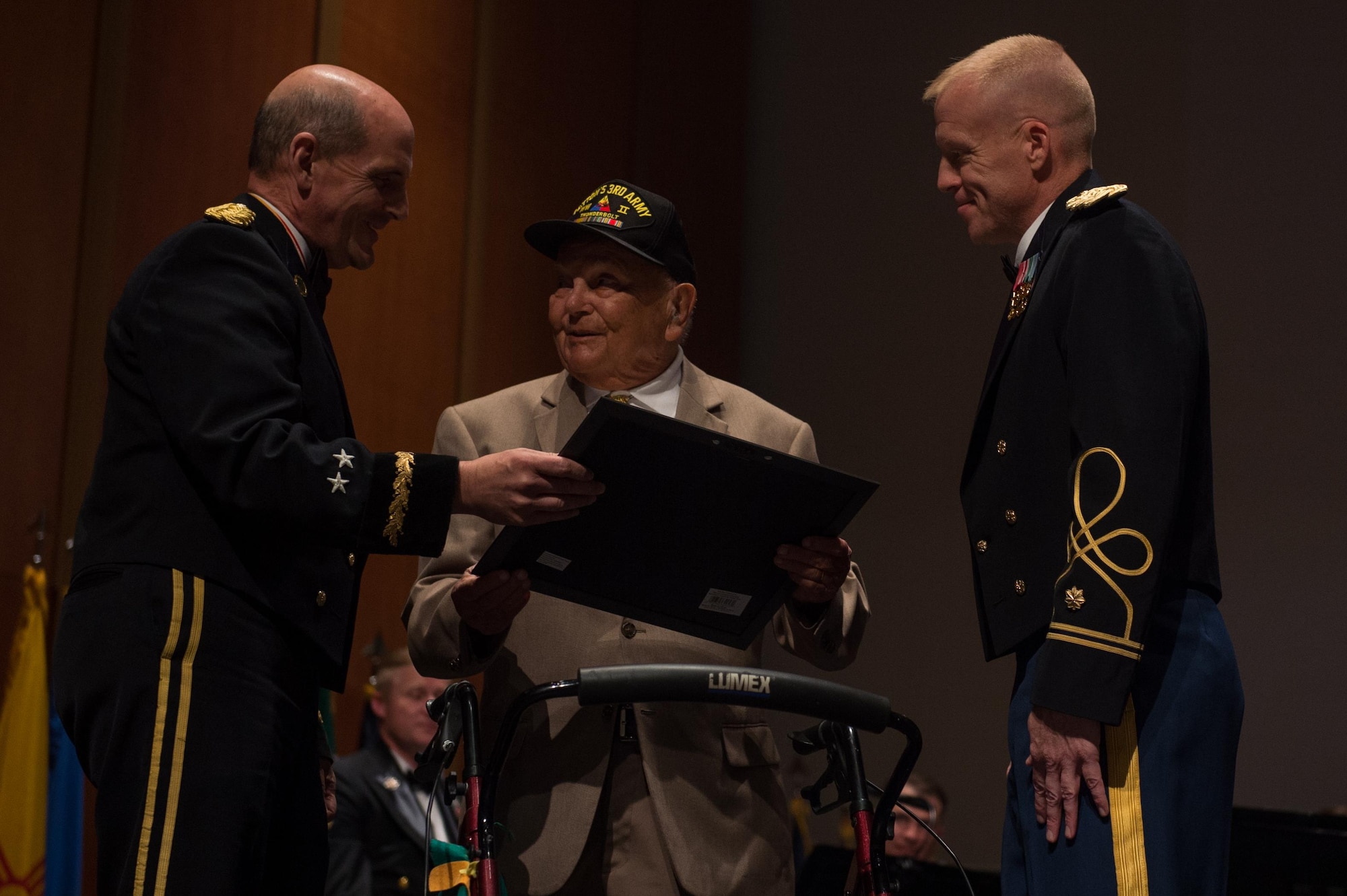U.S. Army Maj. Gen. Paul Benenati, U.S. Army Training and Doctrine Command deputy chief of staff, and Maj. Randall Bartels, TRADOC commander, give a certificate of appreciation to George Crowley, a local veteran, at the Veterans Day Concert in Virginia Beach, Va., Nov. 11, 2016.  Crowley was one of two local veterans whose service was highlighted at the concert. (U.S. Air Force photo by Airman 1st Class Derek Seifert)