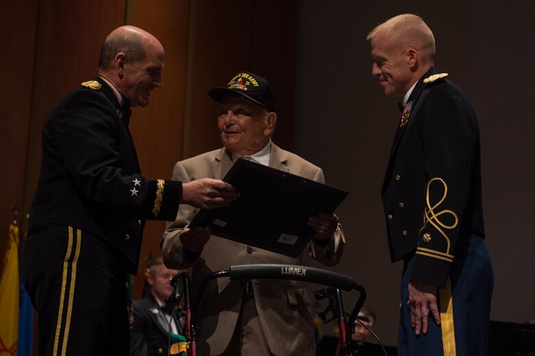 U.S. Army Maj. Gen. Paul Benenati, U.S. Army Training and Doctrine Command deputy chief of staff, and Maj. Randall Bartels, TRADOC commander, give a certificate of appreciation to George Crowley, a local veteran, at the Veterans Day Concert in Virginia Beach, Va., Nov. 11, 2016.  Crowley was one of two local veterans whose service was highlighted at the concert. (U.S. Air Force photo by Airman 1st Class Derek Seifert)