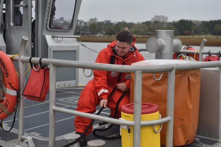 U.S. Coast Guard Fireman David Deaton secures the mooring line Nov. 14, 2016, at USCG Sector Charleston, South Carolina. The boat is tied to a dock in the Charleston Harbor following a man overboard training exercise demonstration. The training is used to simulate recovering someone from the water as quickly and safely as possible. The goal is to accomplish a successful rescue time in less than two minutes.