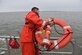 U.S. Coast Guard Fireman David Deaton tosses a life preserver into the water Nov. 14, 2016, at USCG Sector Charleston, South Carolina. The floatation device, equipped with a GPS, is being deployed during a man overboard training exercise to record the rescue time. The goal is to accomplish a successful rescue in less than two minutes. 