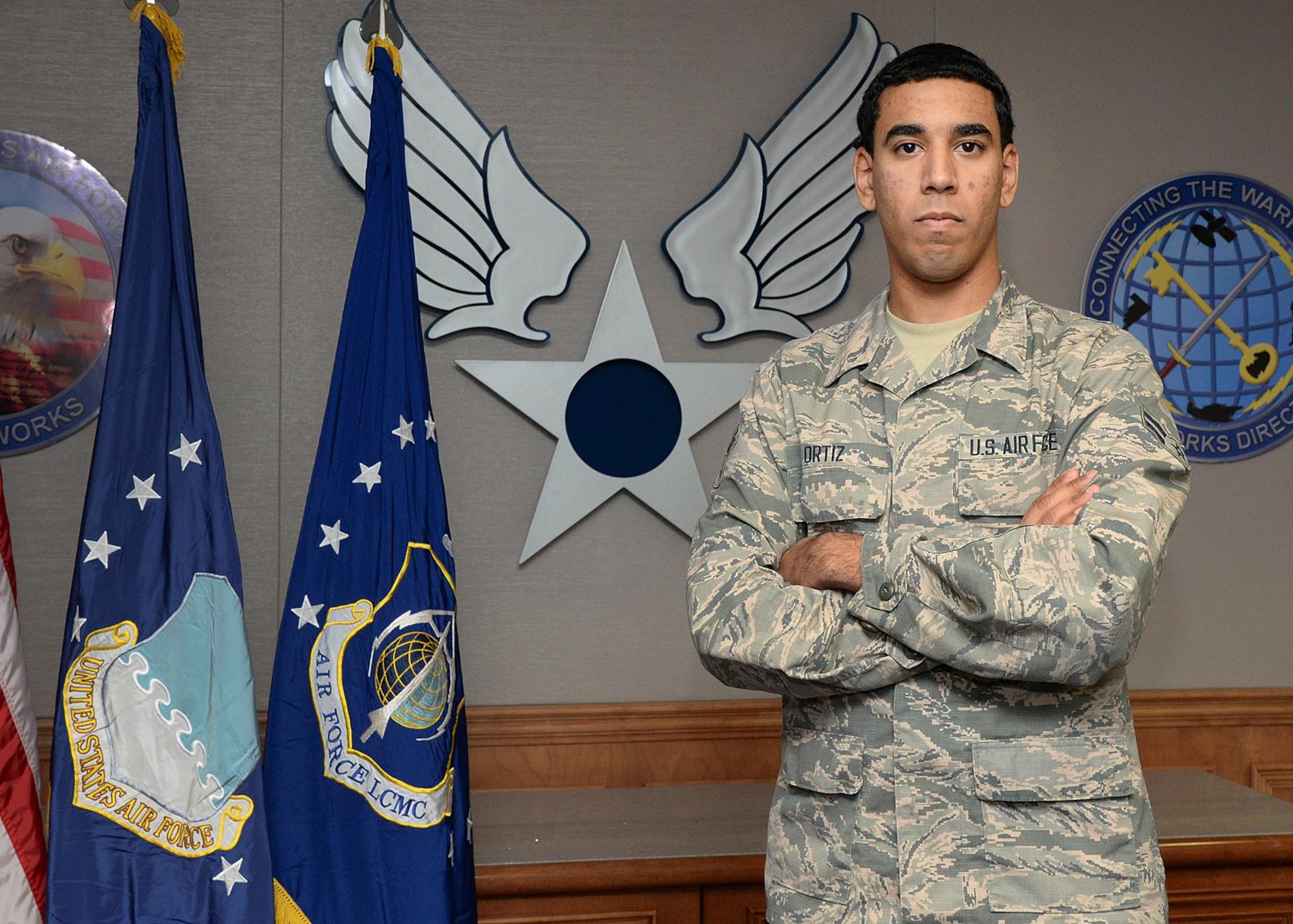 Airman 1st Class Louis A. Ortiz, an administration specialist for the C3I and Networks Directorate, is photographed in Building 1606 at Hanscom Air Force Base, Mass., Nov. 16. Ortiz, who has been in the Air Force for nine months, attributes his success to training he received while enrolled in the U.S. Department of Labor's Job Corps program. (U.S. Air For photo by Linda LaBonte Britt)