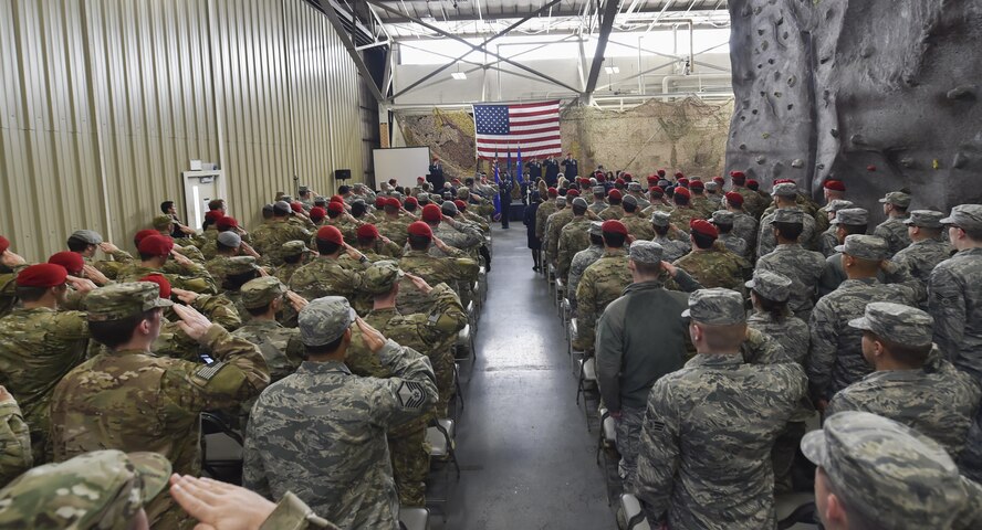 Airmen and soldiers salute during the National Anthem at a Silver Star Medal presentation ceremony at Joint Base Lewis-McChord, Wash., Nov. 16, 2016. The Silver Star Medal was presented to Staff Sgt. Keaton Thiem, a combat controller with the 22nd Special Tactics Squadron, for using air power to ensure the safety of his 100-plus man SOF element during a 14-hour firefight with no regard for his own personal safety, while deployed with U.S. Army Special Operations Forces in Afghanistan. (U.S. Air Force photo by Senior Airman Ryan Conroy)