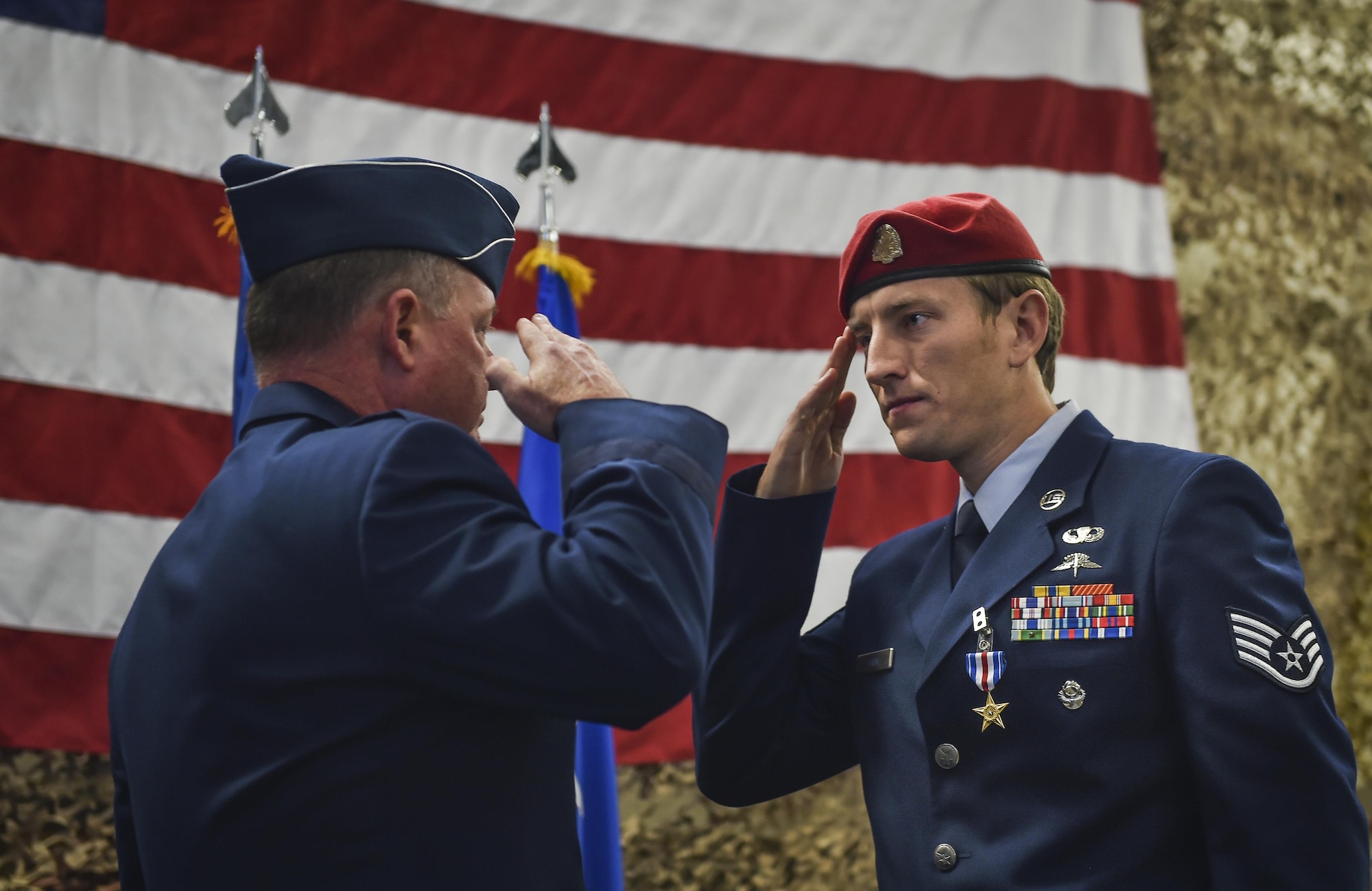 Staff Sgt. Keaton Thiem, a combat controller and Silver Star Medal recipient with the 22nd Special Tactics Squadron,  salutes Maj. Gen. Eugene Haase, vice commander of Air Force Special Operations Command, during a Silver Star Medal presentation ceremony at Joint Base Lewis-McChord, Wash., Nov. 16, 2016. Thiem used air power to ensure the safety of his 100-plus man SOF element during a 14-hour firefight with no regard for his own personal safety, while deployed with U.S. Army Special Operations Forces in Afghanistan. (U.S. Air Force photo by Senior Airman Ryan Conroy) 