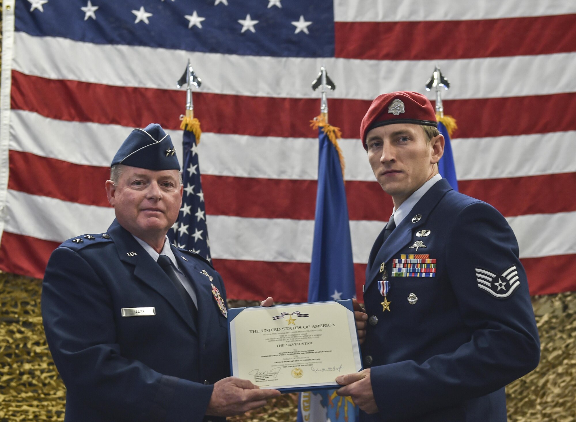 Maj. Gen. Eugene Haase, vice commander of Air Force Special Operations Command, presents Staff Sgt. Keaton Thiem, a combat controller with the 22nd Special Tactics Squadron, the Silver Star Medal at Joint Base Lewis-McChord, Wash., Nov. 16, 2016. Thiem used air power to ensure the safety of his 100-plus man SOF element during a 14-hour firefight with no regard for his own personal safety, while deployed with U.S. Army Special Operations Forces in Afghanistan.(U.S. Air Force photo by Senior Airman Ryan Conroy) 