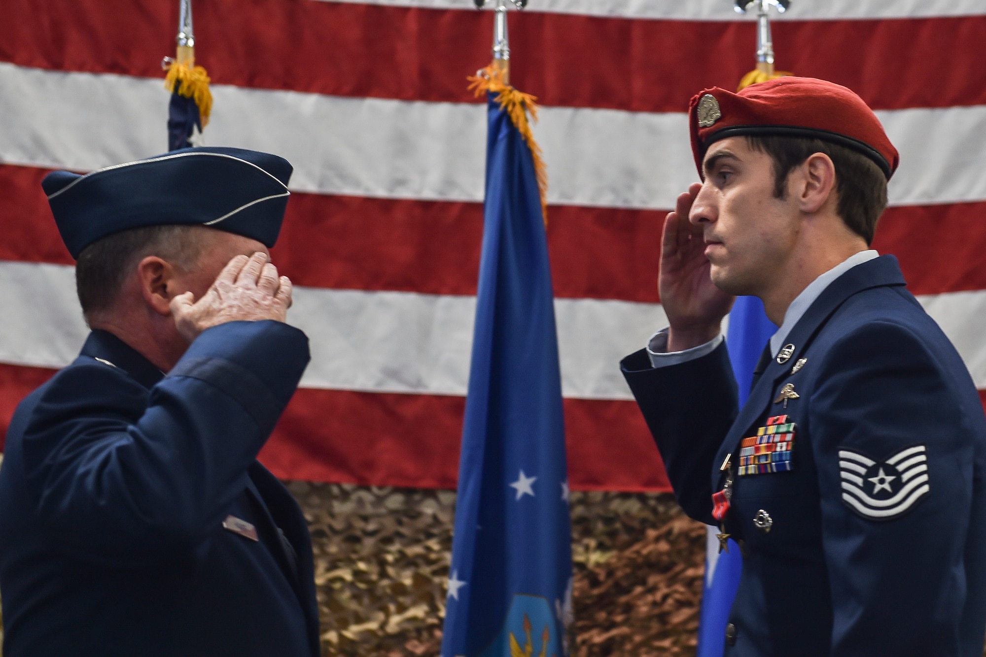 Maj. Gen. Eugene Haase, vice commander of Air Force Special Operations Command, salutes a combat controller with the 22nd Special Tactics Squadron after presenting him with the Bronze Star Medal with valor at Joint Base Lewis-McChord, Wash., Nov. 16, 2016. This Airman, while deployed with a U.S. Army Special Operations Forces team May 7, 2016, eliminated an insider attack in Afghanistan, when a gunman opened fire on joint partners. (U.S. Air Force photo by Senior Airman Ryan Conroy) 