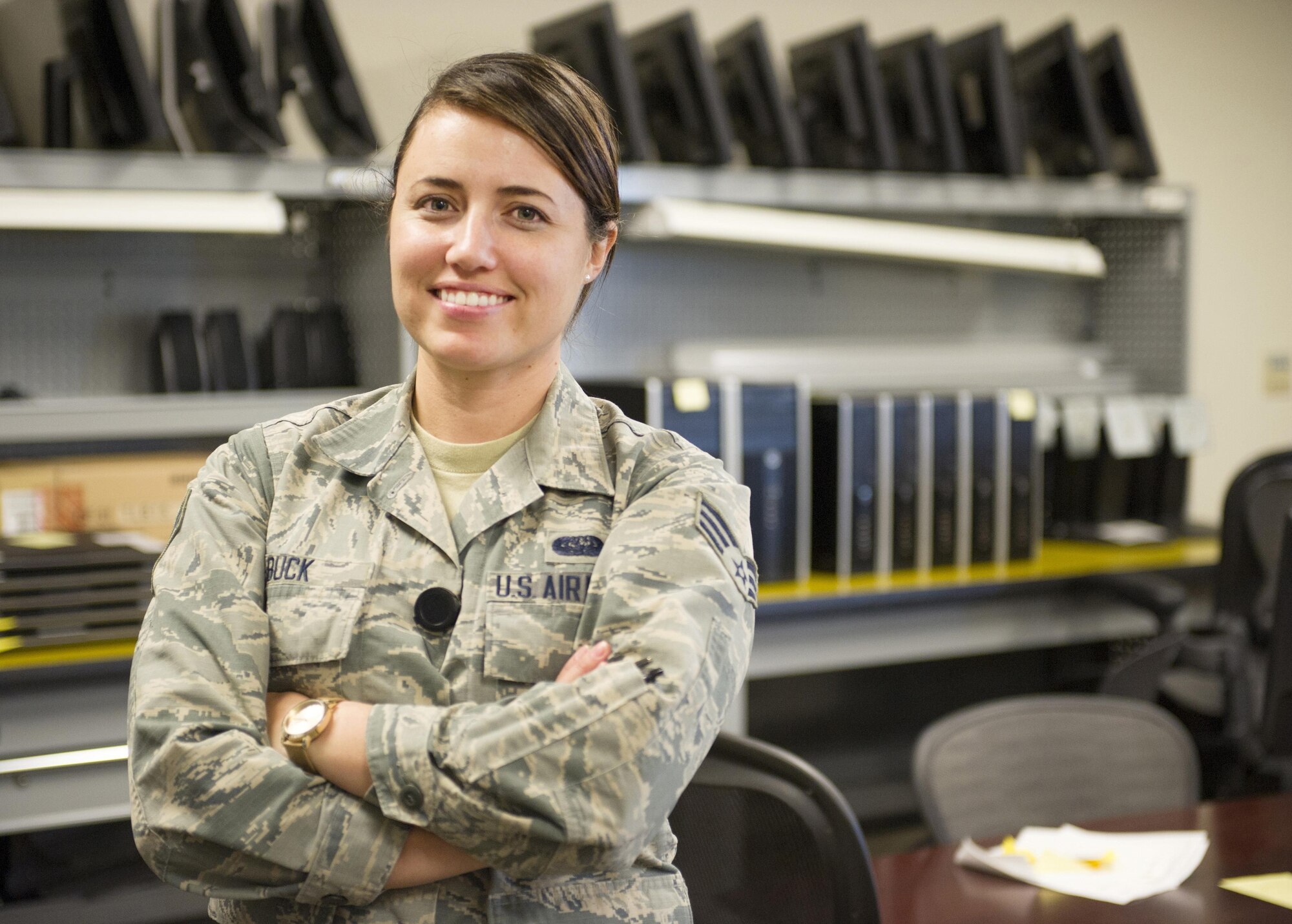 SCHRIEVER AIR FORCE BASE, Colo. — Senior Airman Sandra Buck, 310th Force Support Squadron, poses for a photo in front of equipment lining the shelves of her office Tuesday, Nov. 15, 2016. Airman Buck provides technical support to the 310th Space Wing and all its tenant units on Schriever AFB. (U.S. Air Force photo/Laura Turner)