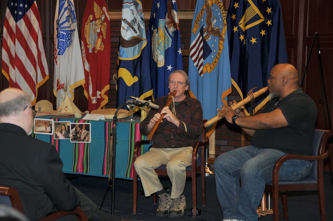 Jim Morehouse (left) and Mitch Thompson play traditional American Indian wooden flutes at a Nov. 16 observance of National American Indian Heritage Month at the McNamara Headquarters Complex.