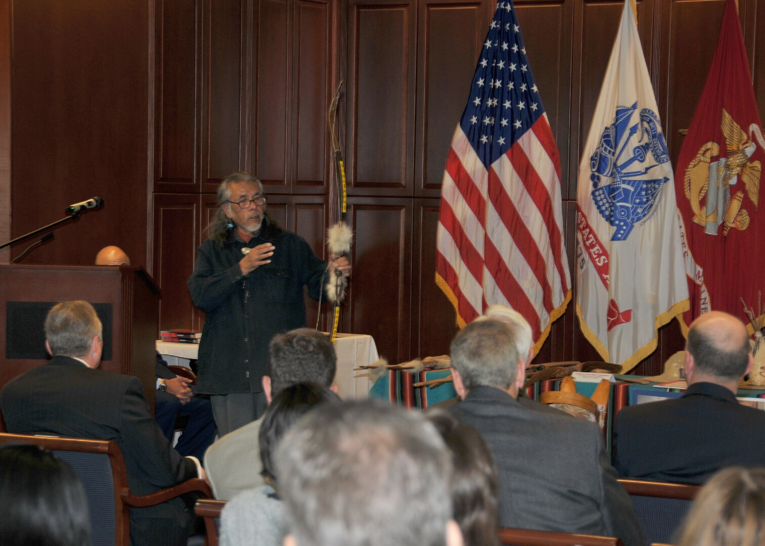 Frederick Tsinnie demonstrates a Navaho bow at a No.v 16 observance of National American Indian Heritage Month. 