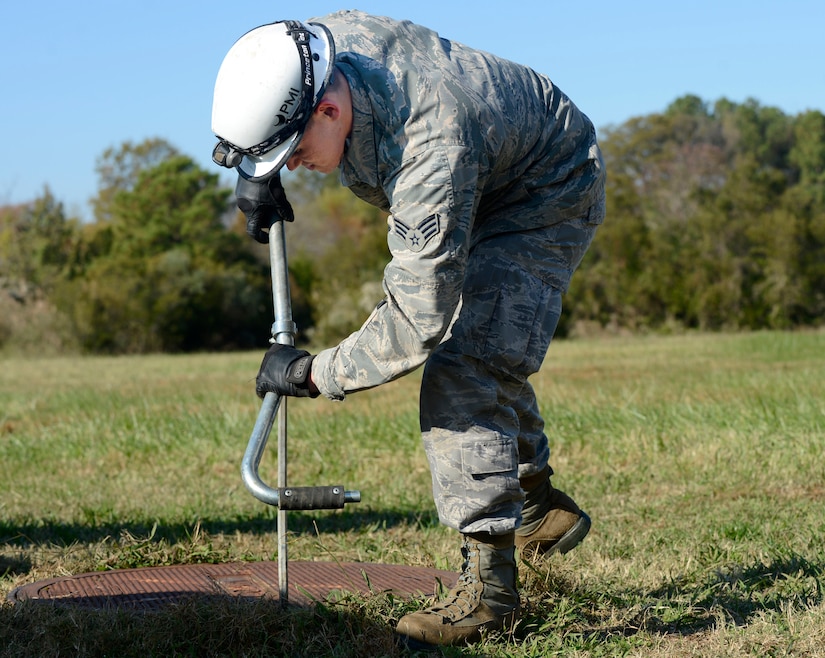 U.S. Air Force Senior Airman Bruce Winsemius, 633rd Communication Squadron cable and antenna technician, opens a manhole at Joint Base Langley-Eustis, Va., Nov. 15, 2016. The 633rd CS cable and antenna Airmen inspect cables throughout base each month as part of their preventive maintenance inspection. (U.S. Air Force photo by Kaylee Dubois)