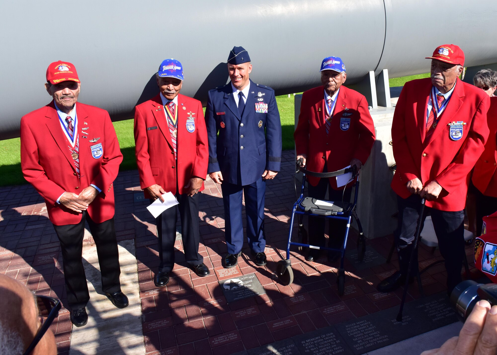 Brig. Gen. Brook Leonard, 56th Fighter Wing commander, stands with original Tuskegee Airmen, Nov. 11 during a ceremony unveiling a red tail granite paver, honoring Tuskegee Airmen experience at the Wesley Bolin Plaza, Phoenix, Arizona. (U.S. Air Force photo by Tech. Sgt. Louis Vega Jr.)