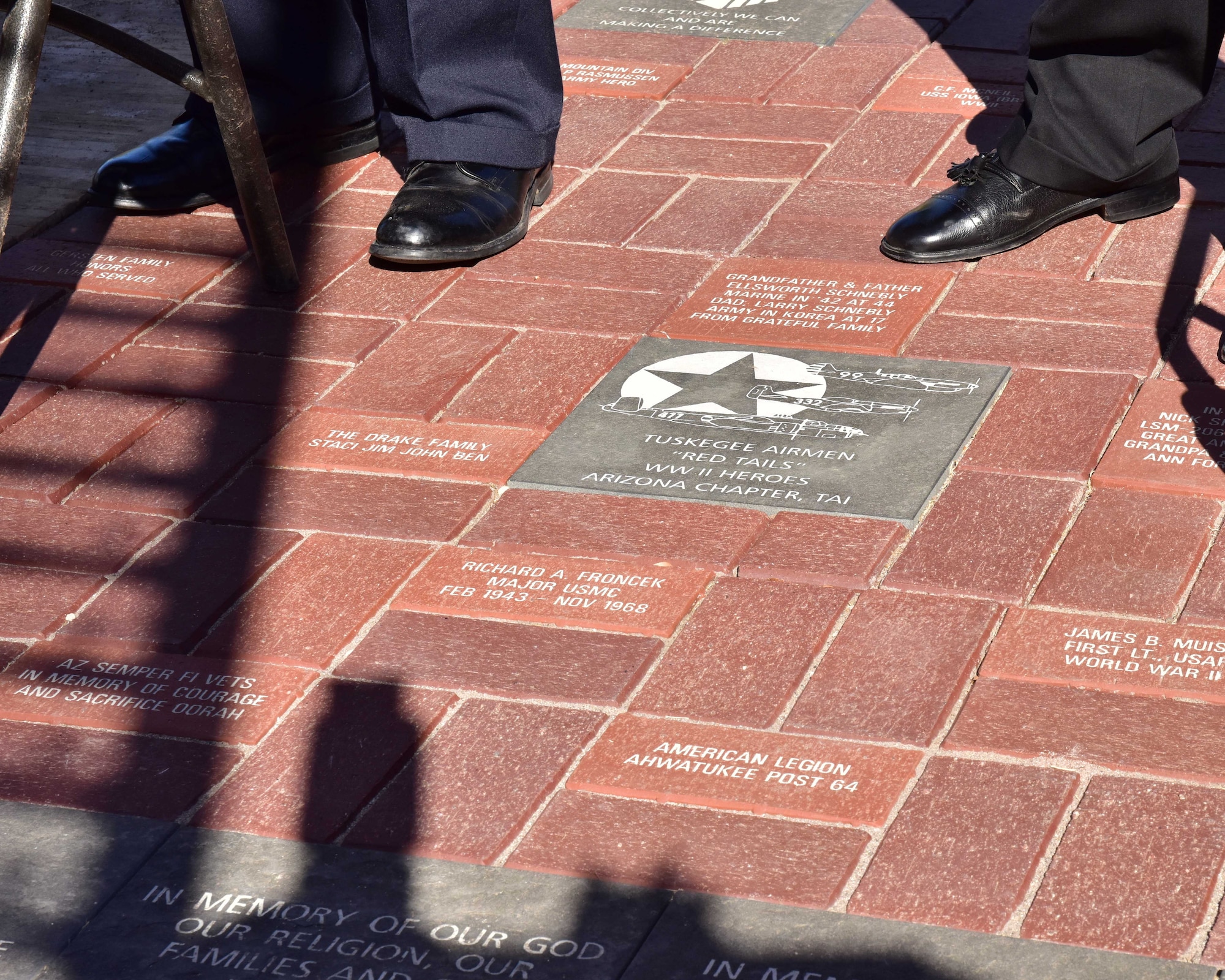 The Archer-Ragsdale Arizona Chapter, Tuskegee Airmen, Inc., unveil a red tail granite paver Nov. 11 during a ceremony honoring the Tuskegee Airmen experience at the Wesley Bolin Plaza, Phoenix, Arizona. (U.S. Air Force photo by Tech. Sgt. Louis Vega Jr.)