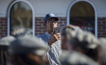 A veteran records Junior ROTC cadets as they march in the Veterans Parade at the State Fair of Louisiana in Shreveport, Nov. 13, 2016. The parade was held in honor of all those who have served the armed forces, past and present. (U.S. Air Force photo/Senior Airman Damon Kasberg)