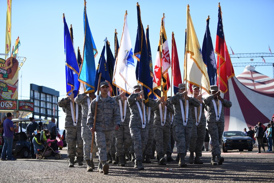 Barksdale Airmen march through the fairgrounds at the State Fair of Louisiana in Shreveport, Nov. 13, 2016. As part of the parade, 50 Airmen marched down the route, each holding a state flag. (U.S. Air Force photo/Airman 1st Class Stuart Bright)