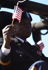 U.S. Army Chief Warrant Officer 3 Louis Wells and waves an American flag during the Veterans Parade at the State Fair of Louisiana in Shreveport, Nov. 13, 2016. Veterans Day is a federal holiday celebrated Nov. 11, during which Americans honor those who have served in the military. (U.S. Air Force photo/Airman 1st Class Stuart Bright)