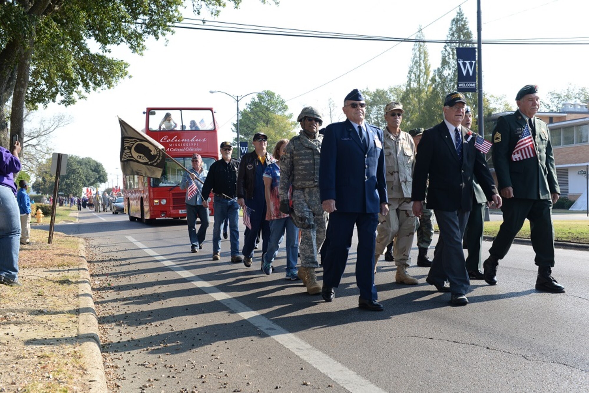 A formation of veterans from across the military services march to the Lowndes County Court House during the 2016 Columbus Veterans Day Parade Nov. 12, 2016, in Columbus, Mississippi. Parade participants included the veteran formation, a formation of Airmen from Columbus Air Force Base, local high school bands and flag twirlers and a multitude of vintage vehicles. (U.S. Air Force photo by Airman 1st Class John Day)