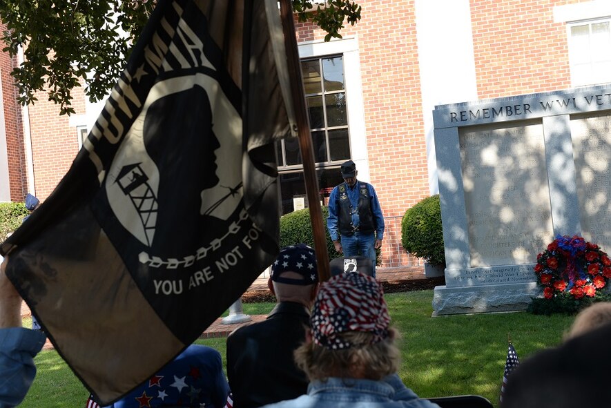 RJ Childers, American Legion Post 69, lays a POW/MIA chair cover at the 2016 Columbus Veterans Day Wreath-Laying Ceremony Nov. 12, 2016, at the Lowndes County Court House in Columbus, Mississippi. The empty chair was set to symbolize its availability for those that are still missing in action. (U.S. Air Force photo by Airman 1st Class John Day)