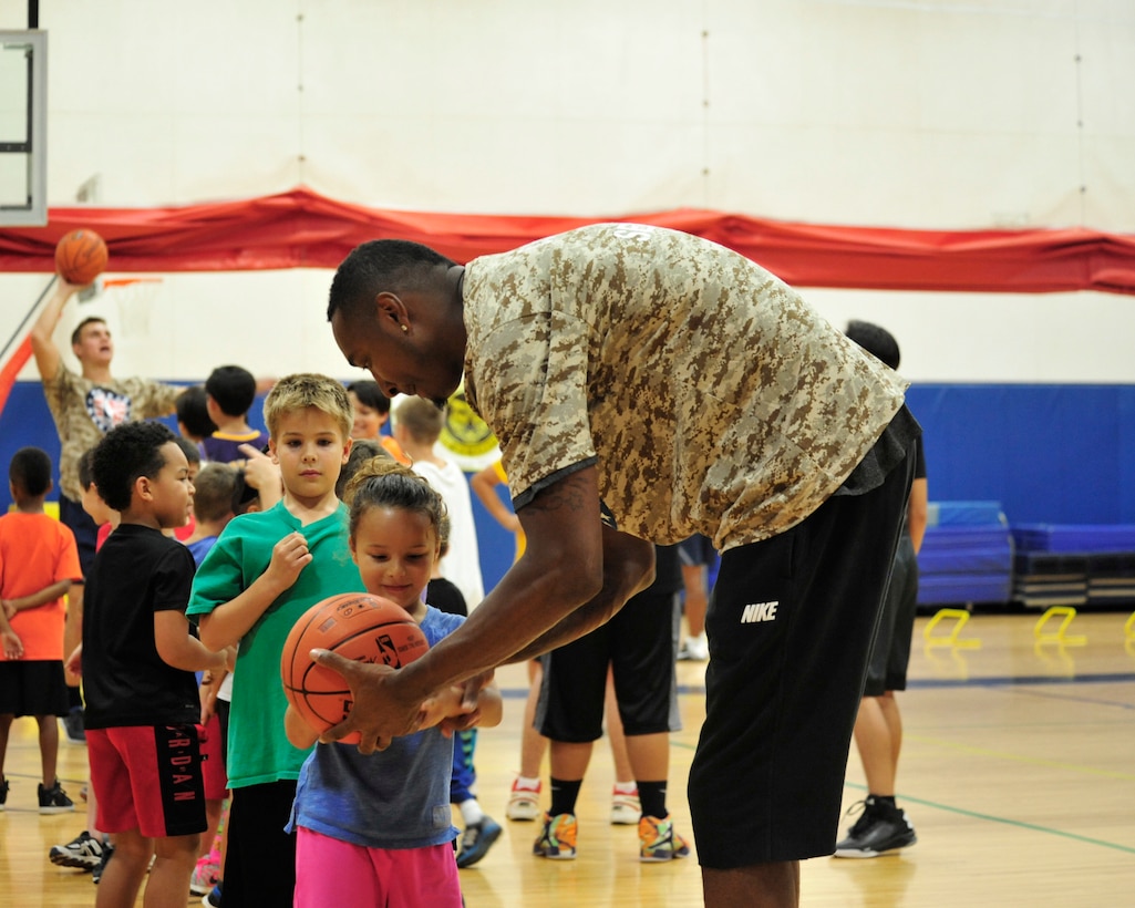 Steven Hunter, Phoenix Suns alumni and community ambassador, talks to a child during the Basketball Clinic event held Nov. 10, 2016 at Luke Air Force Base Youth Center.  (U.S. Air Force photo by Denise Willhite)