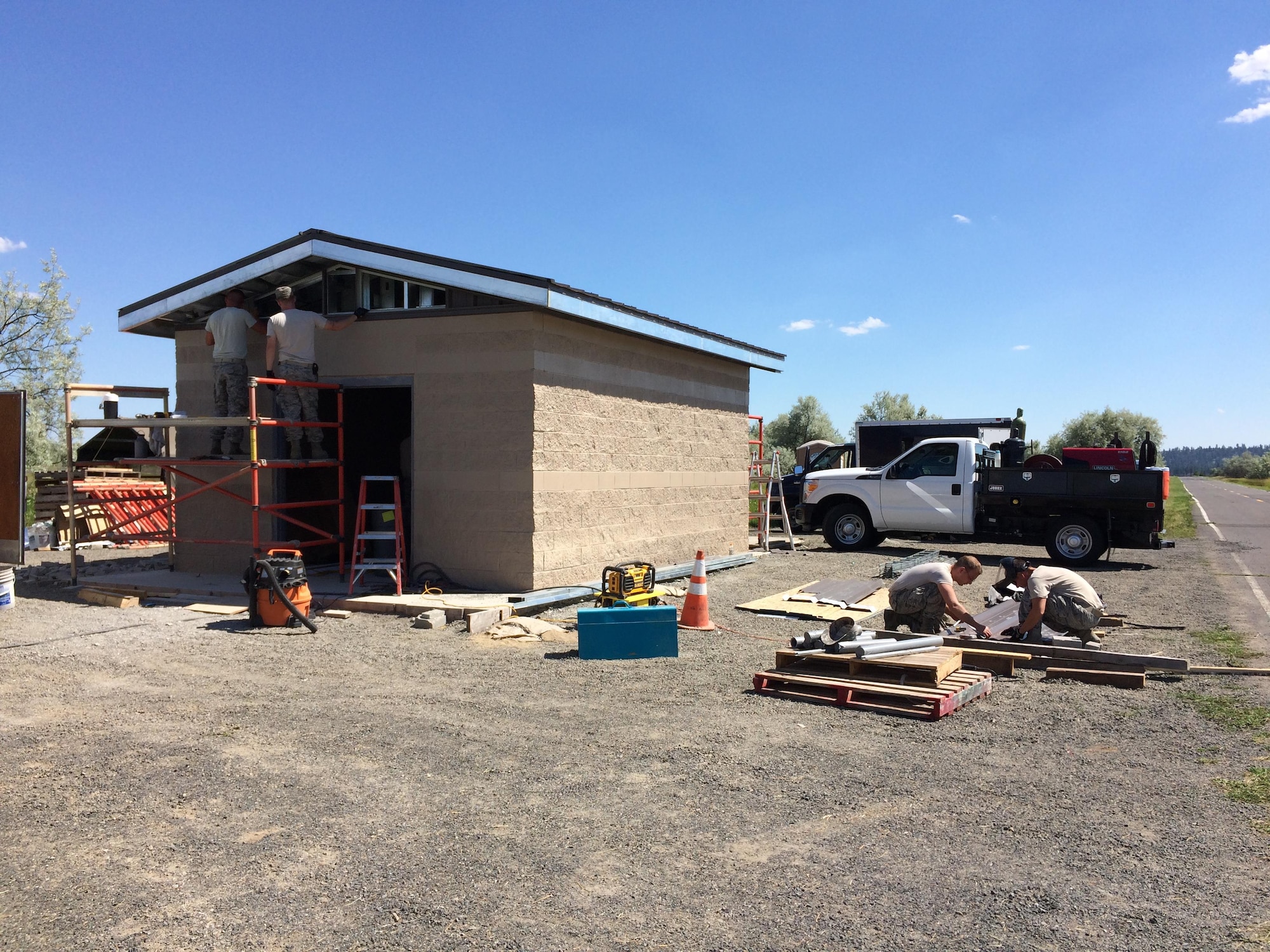 Airmen from the 92nd Civil Engineer Squadron work on the outside of the pump house June 29, 2016, at Fairchild Air Force Base, Wash. The original pump house was built in 1976 and the facility was in need of a full upgrade after the pumps were replaced in 2011. (Courtesy photo)