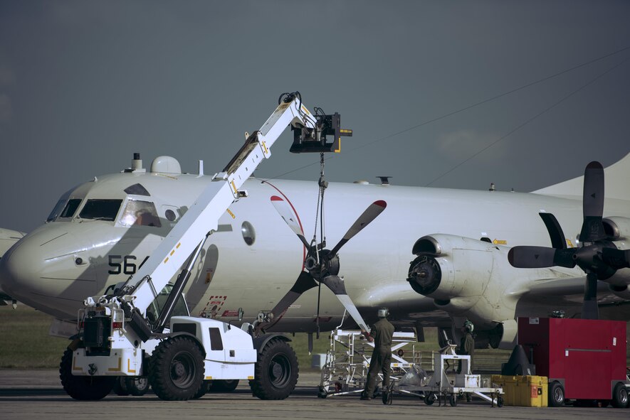 U.S. Navy maintainers replace the propeller to a P-3 Orion Nov. 8, 2016, at Kadena Air Base, Japan. The P-3 Orion specializes in anti-submarine warfare and search and rescues missions. (U.S. Air Force photo by Senior Airman Omari Bernard)