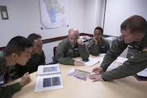 U.S. Air Force Capt. Jonathan Coffey, right, 459th Airlift Squadron UH-1N pilot, conducts a mission brief at Yokota Air Base, Japan, Nov. 8, 2016, during the Keen Sword 17. The 459th AS and Komatsu Air RQS Airmen conducted a three-day NVGs and hoist familiarization training. (U.S. Air Force photo by Yasuo Osakabe/Released)  