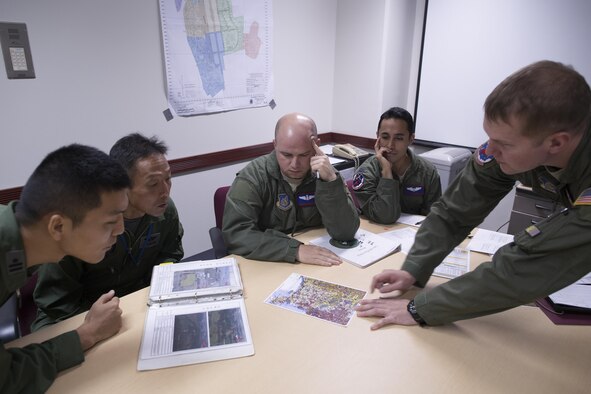 U.S. Air Force Capt. Jonathan Coffey, right, 459th Airlift Squadron (AS) UH-1N pilot, conducts a mission brief at Yokota Air Base, Japan, Nov. 8, 2016, during Keen Sword (KS) 17. The 459th AS and Komatsu Air Rescue Squadron Airmen conducted a three-day night vision goggle and hoist familiarization training.  KS17 provides a realistic training environment that allows U.S. and Japan Self-Defense Forces to respond to a wide range of situations.  (U.S. Air Force photo by Yasuo Osakabe/Released)  