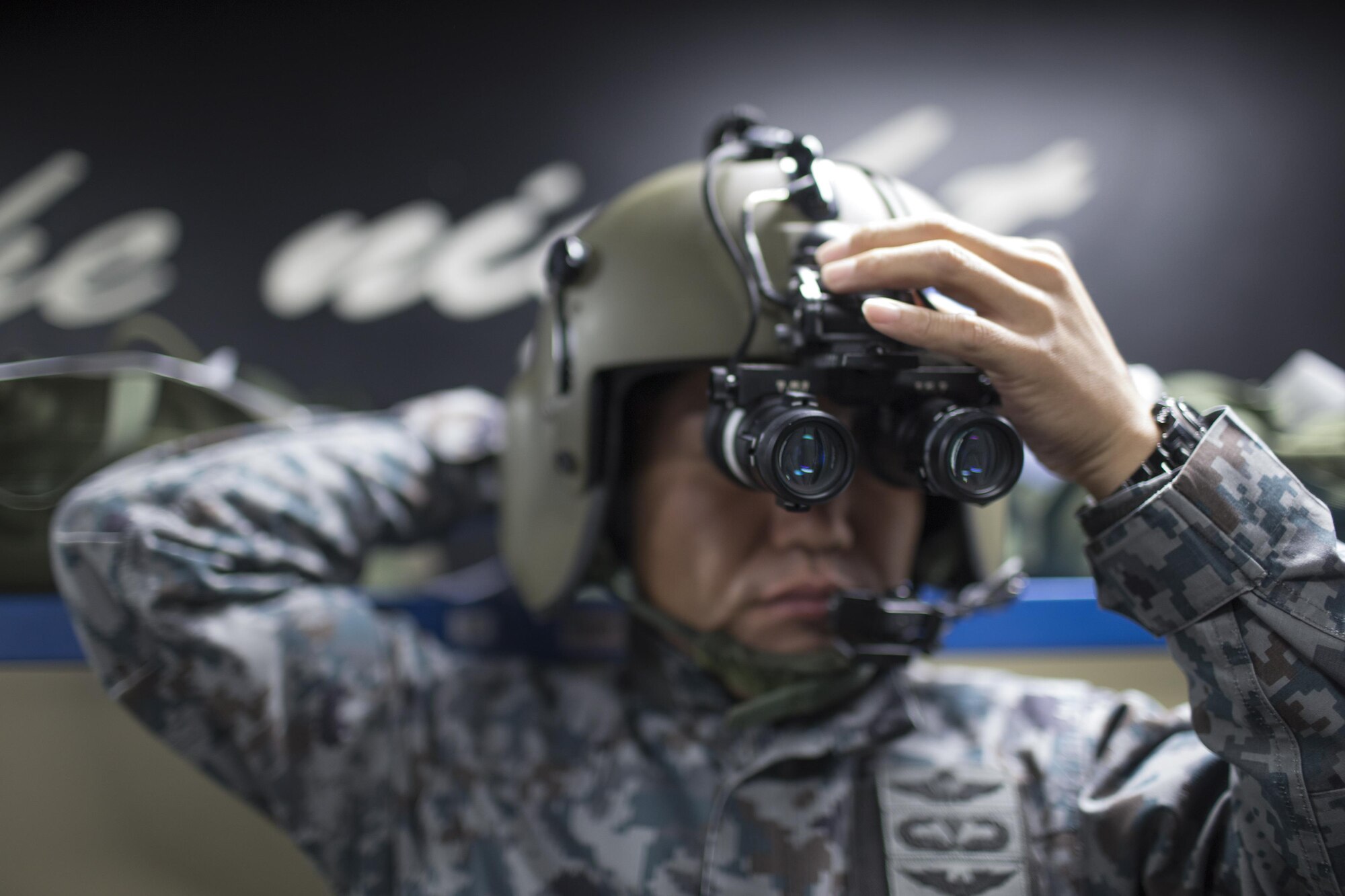 Japan Air Self-Defense Force Tech. Sgt. Shohei Sakane, Komaki Air Rescue Squadron pararescue jumper, adjusts his night vision goggles at Yokota Air Base, Japan, Nov. 8, 2016, during the Keen Sword 17. The 459th AS and Komatsu Air RQS Airmen conducted a three-day NVGs and hoist familiarization training. (U.S. Air Force photo by Yasuo Osakabe/Released)  