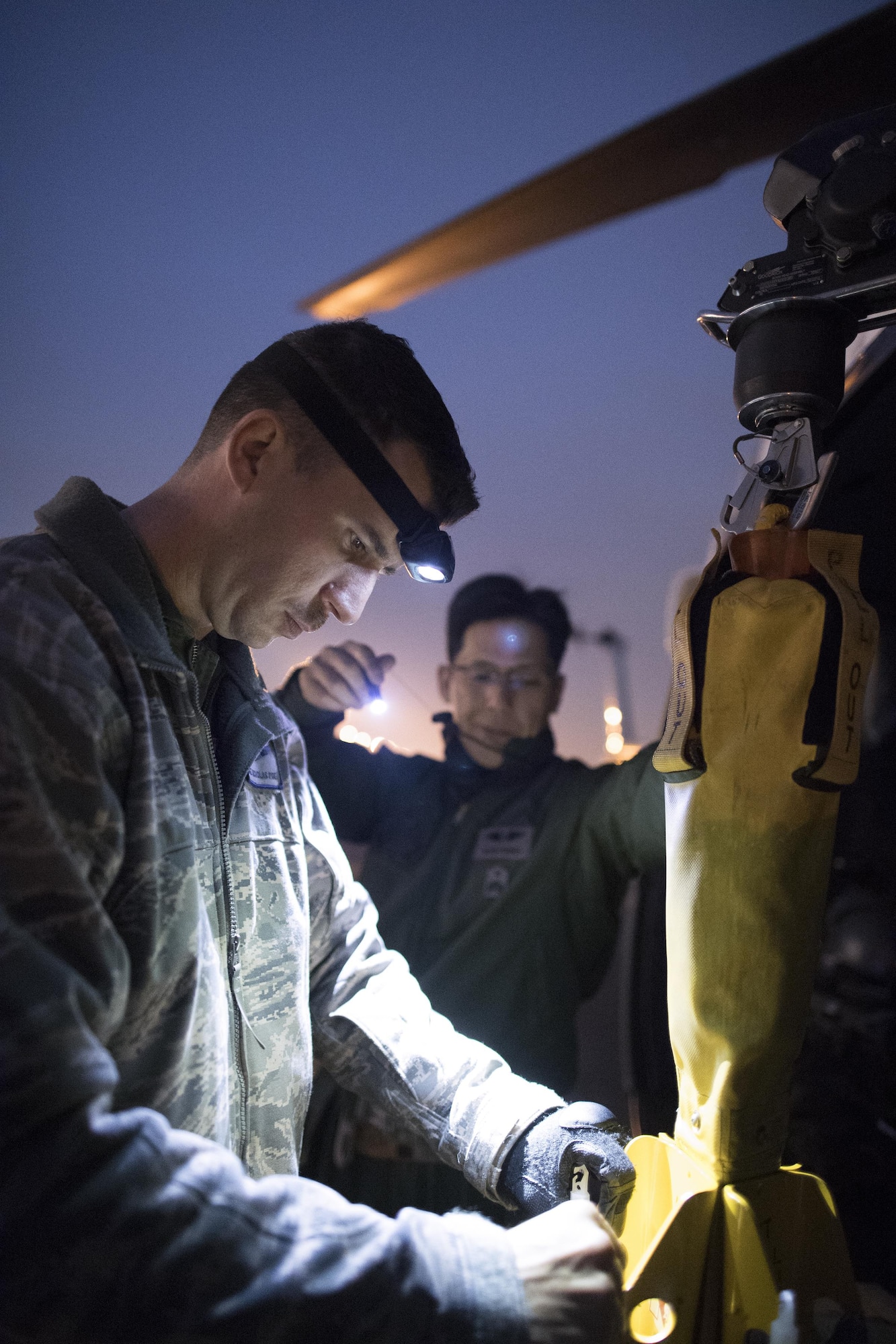 U.S. Air Force Staff Sgt. Nicholas Poe, 459th Airlift Squadron special mission aviator, performs pre-flight inspection at Yokota Air Base, Japan, Nov. 8, 2016, during the Keen Sword 17. The 459th AS and Komatsu Air RQS Airmen conducted a three-day NVGs and hoist familiarization training. (U.S. Air Force photo by Yasuo Osakabe/Released)  