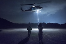 (Right to left) Japan Air Self-Defense Force Tech.Sgt. Shohei Sakane, Komatsu Air Rescue Squadron pararesuce jumper, and JASDF Tech. Sgt. Yuji Yasutani, Komatsu Air RQS UH-60J flight engineer, walk to a U.S. Air Force UH-1N Iroquois at Combined Arms Training Center Camp Fuji, Nov. 8, 2016, during the Keen Sword 17. The 459th AS and Komatsu Air RQS Airmen conducted a three-day NVGs and hoist familiarization training. (U.S. Air Force photo by Yasuo Osakabe/Released)  