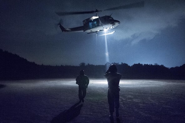 (Right to left) Japan Air Self-Defense Force (JASDF) Tech.Sgt. Shohei Sakane, Komatsu Air Rescue Squadron (RQS) pararesuce jumper, and JASDF Tech. Sgt. Yuji Yasutani, Komatsu Air RQS UH-60J flight engineer, walk to a U.S. Air Force UH-1N Iroquois at the Combined Arms Training Center, Camp Fuji, Japan, Nov. 8, 2016, during Keen Sword 17. The exercise is the latest in a series of joint, bilateral field training exercises since 1986 involving U.S. military and Japan Self-Defense Forces personnel designed to increase combat readiness and interoperability of the Japan-U.S. alliance.  (U.S. Air Force photo by Yasuo Osakabe/Released)  