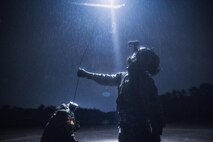 (Right to left) Japan Air Self-Defense Force Tech Sgt. Shohei Sakane, Komatsu Air Rescue Squadron pararescue jumper, and JASDF Tech. Sgt. Yuji Yasutani, Komatsu ARQS UH-60J flight engineer, get hoisted to an U.S. Air Force UH-1N Iroquois at Combined Arms Training Center Camp Fuji, Nov. 8, 2016, during the Keen Sword 17. The 459th AS and Komatsu Air RQS Airmen conducted a three-day NVGs and hoist familiarization training. (U.S. Air Force photo by Yasuo Osakabe/Released)  