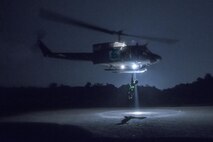 Japan Air Self-Defense Force Tech. Sgt. Shohei Sakane, Komatsu Air Rescue Squadron pararescue jumper, gets hoisted to an U.S. Air Force UH-1N Iroquois at Combined Arms Training Center Camp Fuji, Nov. 8, 2016, during the Keen Sword 17. The 459th AS and Komatsu Air RQS Airmen conducted a three-day NVGs and hoist familiarization training. (U.S. Air Force photo by Yasuo Osakabe/Released)  