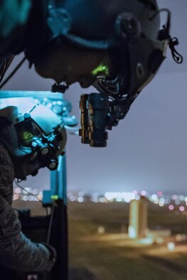 Japan Air Self-Defense Force Master Sgt. Yasuhiro Maetsuru, front, Komatsu Air Rescue Squadron (RQS) UH-60J flight engineer, watches a hoist demonstration performed by U.S. Air Force Staff Sgt. Nicholas Poe, back, 459th Airlift Squadron (AS) UH-1N flight engineer, over Yokota Air Base, Japan, Nov. 8, 2016, during Keen Sword 17. The 459th AS and Komatsu Air RQS Airmen conducted a three-day NVGs and hoist familiarization training. The exercise is the latest in a series of joint, bilateral field training exercises since 1986 involving U.S. military and Japan Self-Defense Forces personnel designed to increase combat readiness and interoperability of the Japan-U.S. alliance.  (U.S. Air Force photo by Yasuo Osakabe/Released)