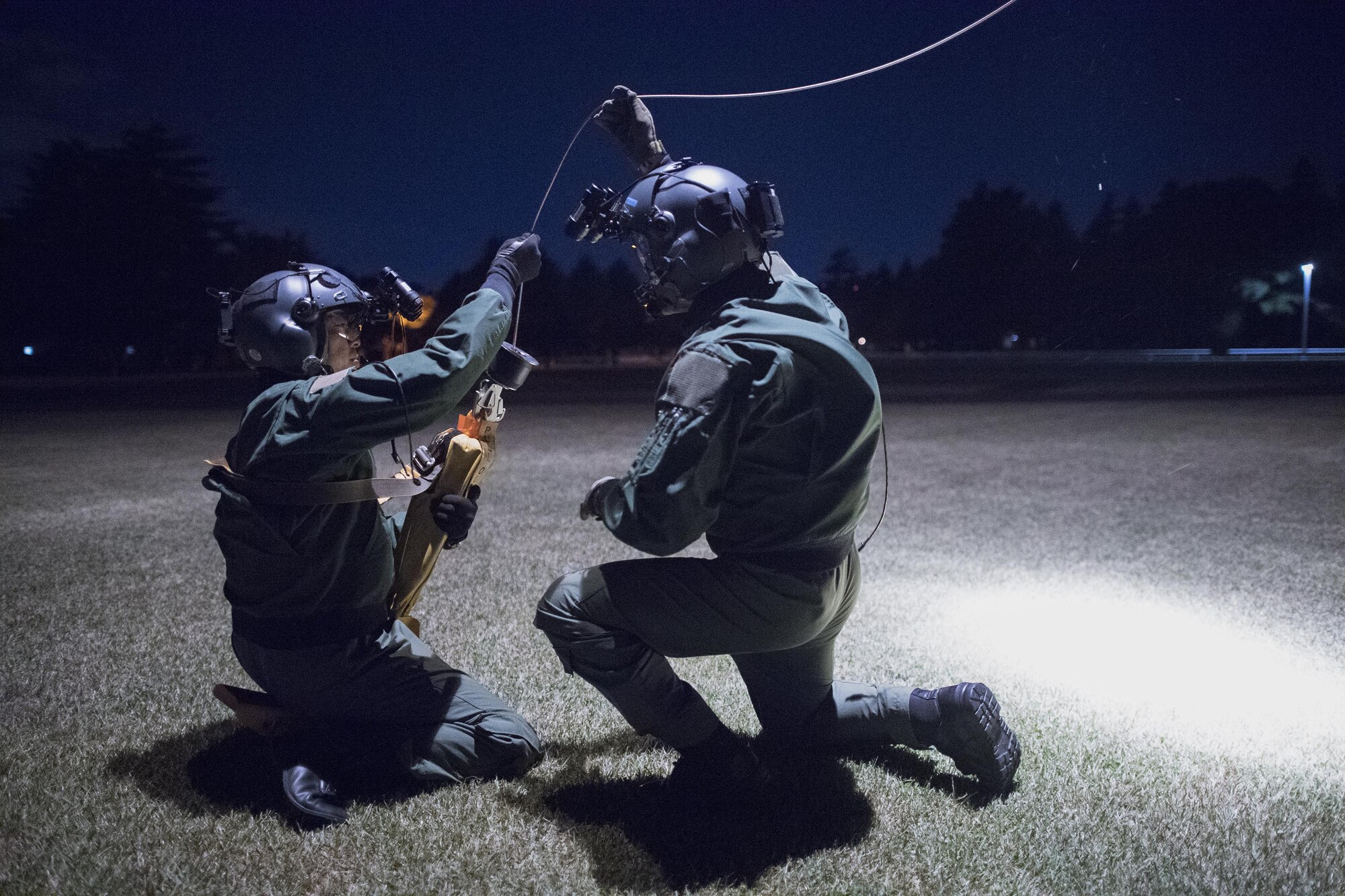 (Left to right) Japan Air Self-Defense Force Maj. Hirotaka Nakamura and Maj. Junichi Okamoto, Komatsu Air Rescue Squadron UH-60J pilots, conduct a hoist training at U.S. Army Sagami General Depot, Nov. 9, 2016, during the Keen Sword 17. The 459th AS and Komatsu Air RQS Airmen conducted a three-day NVGs and hoist familiarization training. (U.S. Air Force photo by Yasuo Osakabe/Released)  