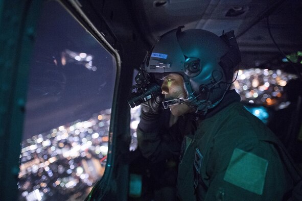 Japan Air Self-Defense Force Capt. Daichi Nukimoto, Komatsu Air Rescue Squadron (RQS) U125A pilot, performs visual confirmation with night vision goggles over U.S. Army Sagami Depot, Nov. 9, 2016, during Keen Sword 17. The 459th Airlift Squadron and Komatsu Air RQS Airmen conducted a three-day NVGs and hoist familiarization training. Keen Sword provides a realistic training environment that allows U.S. and Japan Self-Defense Forces to respond to a wide range of situations. (U.S. Air Force photo by Yasuo Osakabe/Released)  