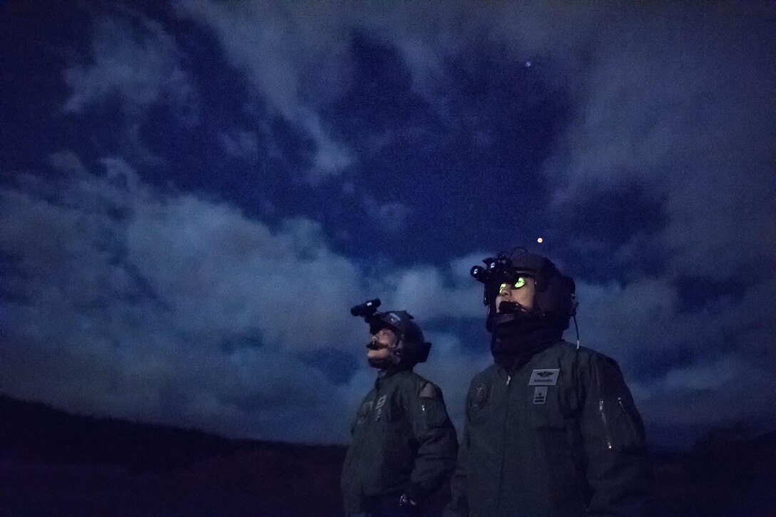 (Right to left) Japan Air Self-Defense Force Maj. Hirotaka Nakamura, Komatsu Air Rescue Squadron UH-60J pilot, and JASDF Capt. Daichi Nukimoto, Komatsu Air RQS U125A pilot, perform visual conformation checks at Combined Arms Training Center Camp Fuji, Nov. 9, 2016, during the Keen Sword 17. The 459th AS and Komatsu Air RQS Airmen conducted a three-day NVGs and hoist familiarization training. (U.S. Air Force photo by Yasuo Osakabe/Released)  