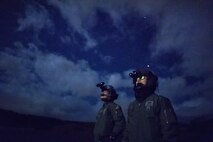 (Right to left) Japan Air Self-Defense Force Maj. Hirotaka Nakamura, Komatsu Air Rescue Squadron UH-60J pilot, and JASDF Capt. Daichi Nukimoto, Komatsu Air RQS U125A pilot, perform visual conformation checks at Combined Arms Training Center Camp Fuji, Nov. 9, 2016, during the Keen Sword 17. The 459th AS and Komatsu Air RQS Airmen conducted a three-day NVGs and hoist familiarization training. (U.S. Air Force photo by Yasuo Osakabe/Released)  