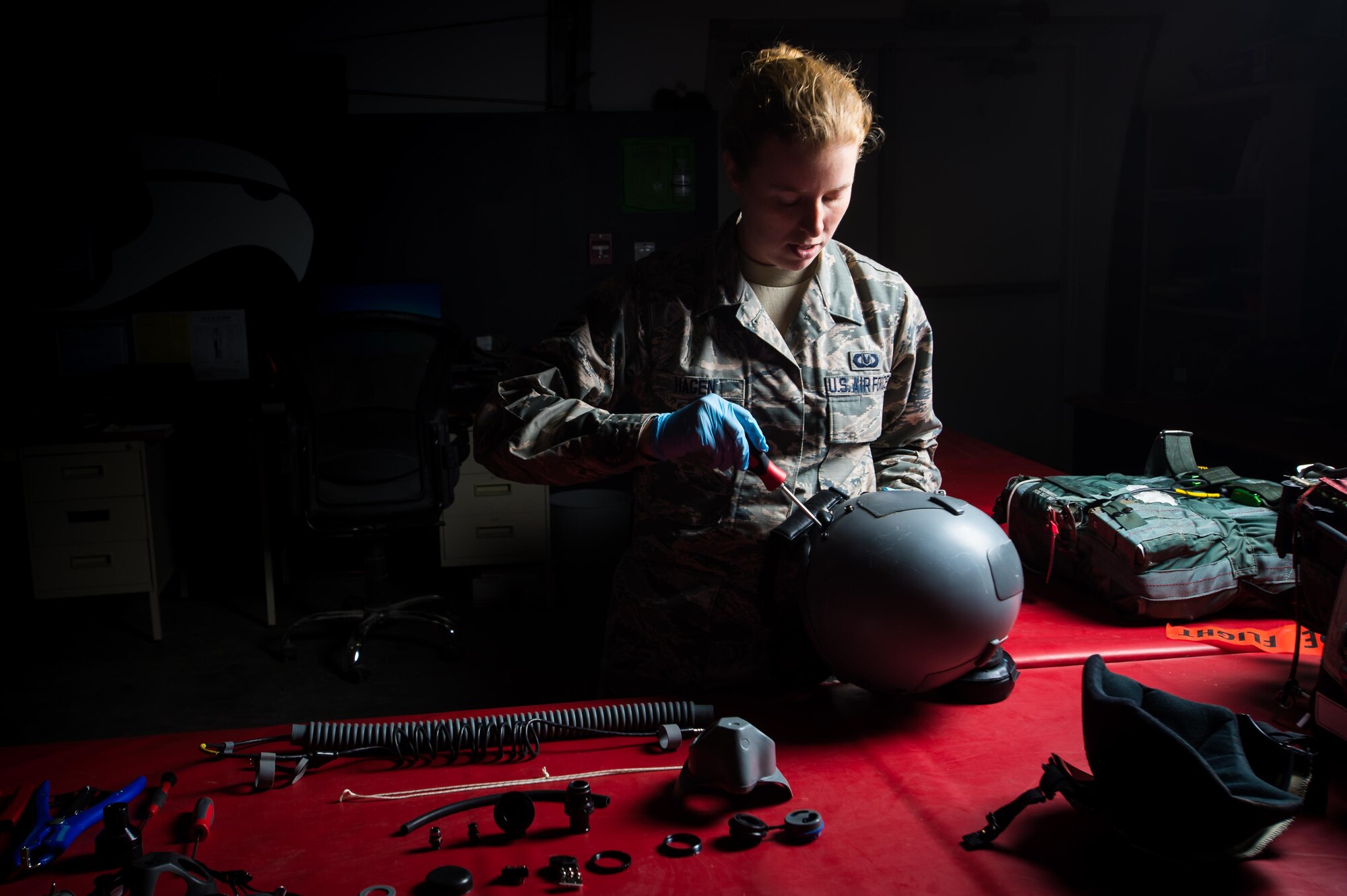 Aircrew Flight Equipment technician Airman 1st Class Kristen, a member of the 380th Air Expeditionary Wing, prepares a high performance helmet for a pilot at an undisclosed location in Southwest Asia, Nov. 11, 2016. “Since Aircrew Flight Equipment directly supports the Pilots and the F-22 aircraft safety features we directly tie into the mission of enabling the F-22's expeditionary war fighting capability,” Kristen said. (U.S. Air Force photo by Senior Airman Tyler Woodward)