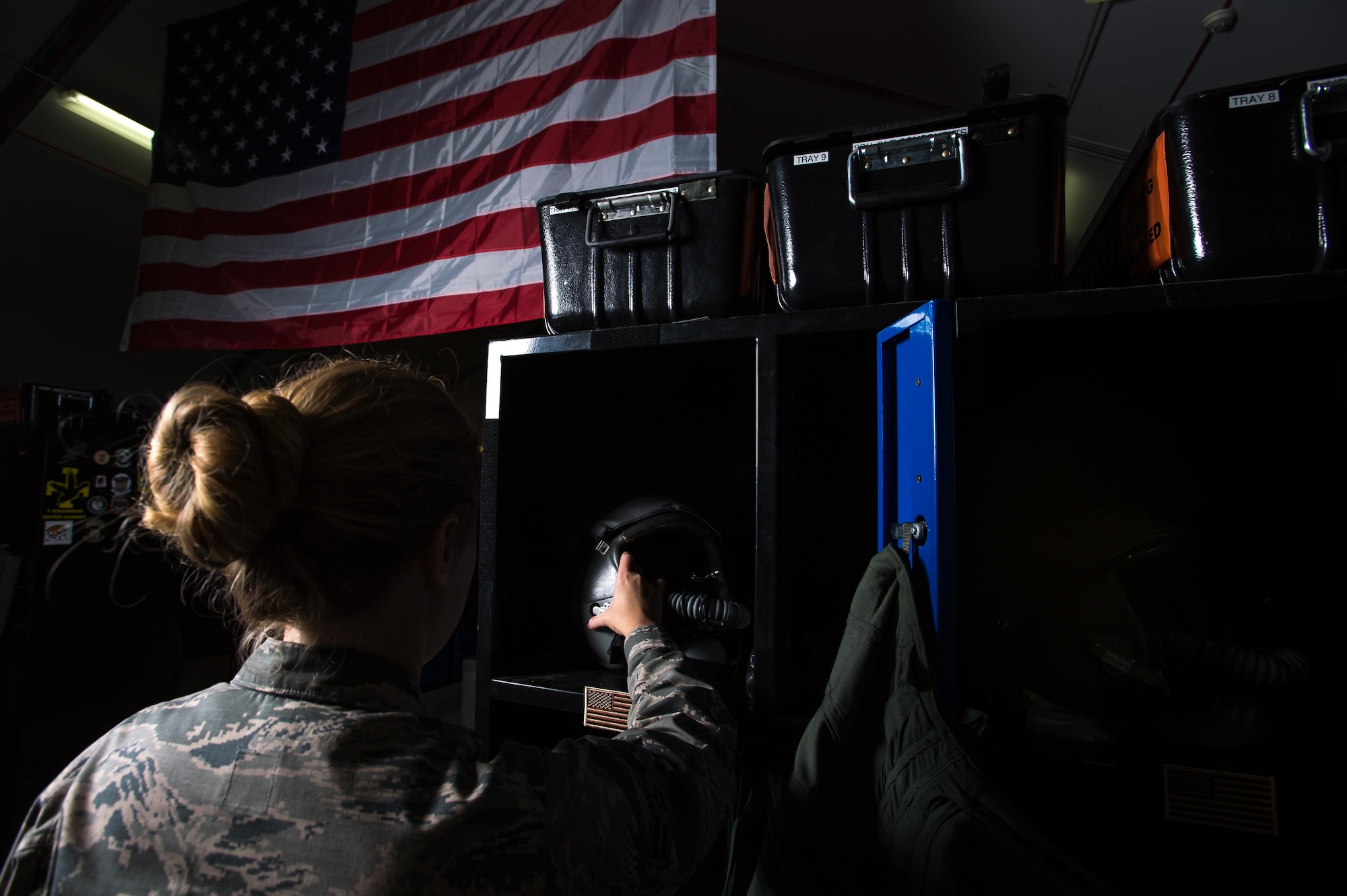 Aircrew Flight Equipment technician Airman 1st Class Kristen, a member of the 380th Air Expeditionary Wing, places a high performance helmet in an F-22 pilot’s locker at an undisclosed location in Southwest Asia, Nov. 11, 2016. “I maintain equipment like anti-gravity suits that enhance the pilots’ performance as well as survival vests that contain components such as recovery radios which help the pilot survive in a situation when they are to be rescued,” Kristen said. (U.S. Air Force photo by Senior Airman Tyler Woodward)